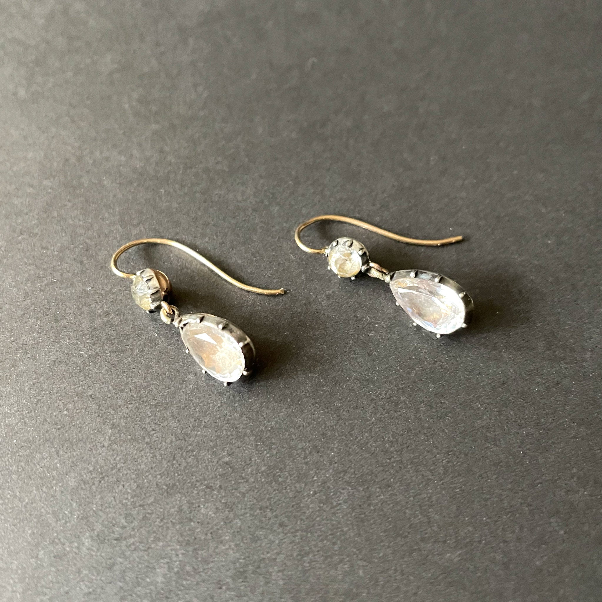 Antique paste earrings on a black background.