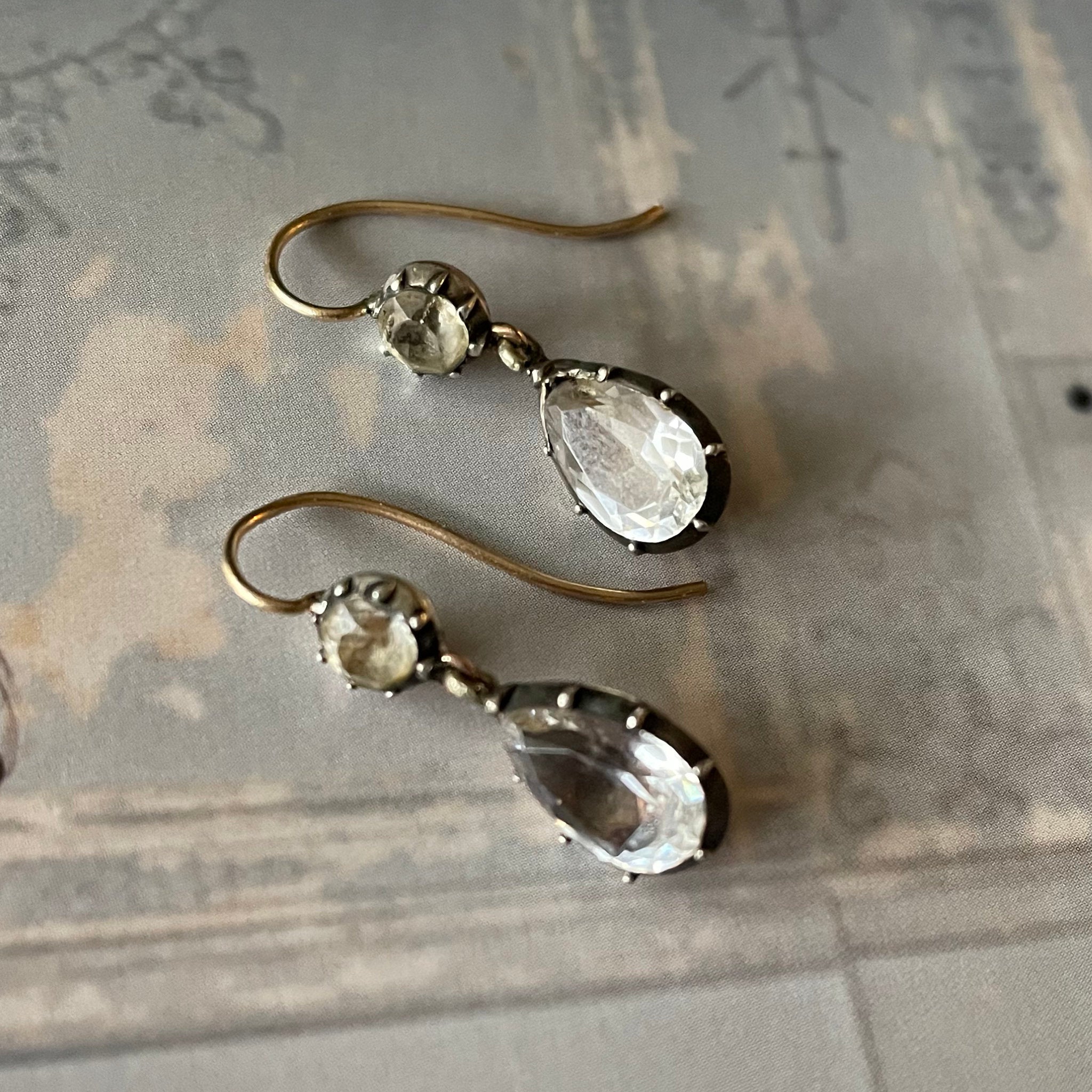 Paste earrings close up on blue.
