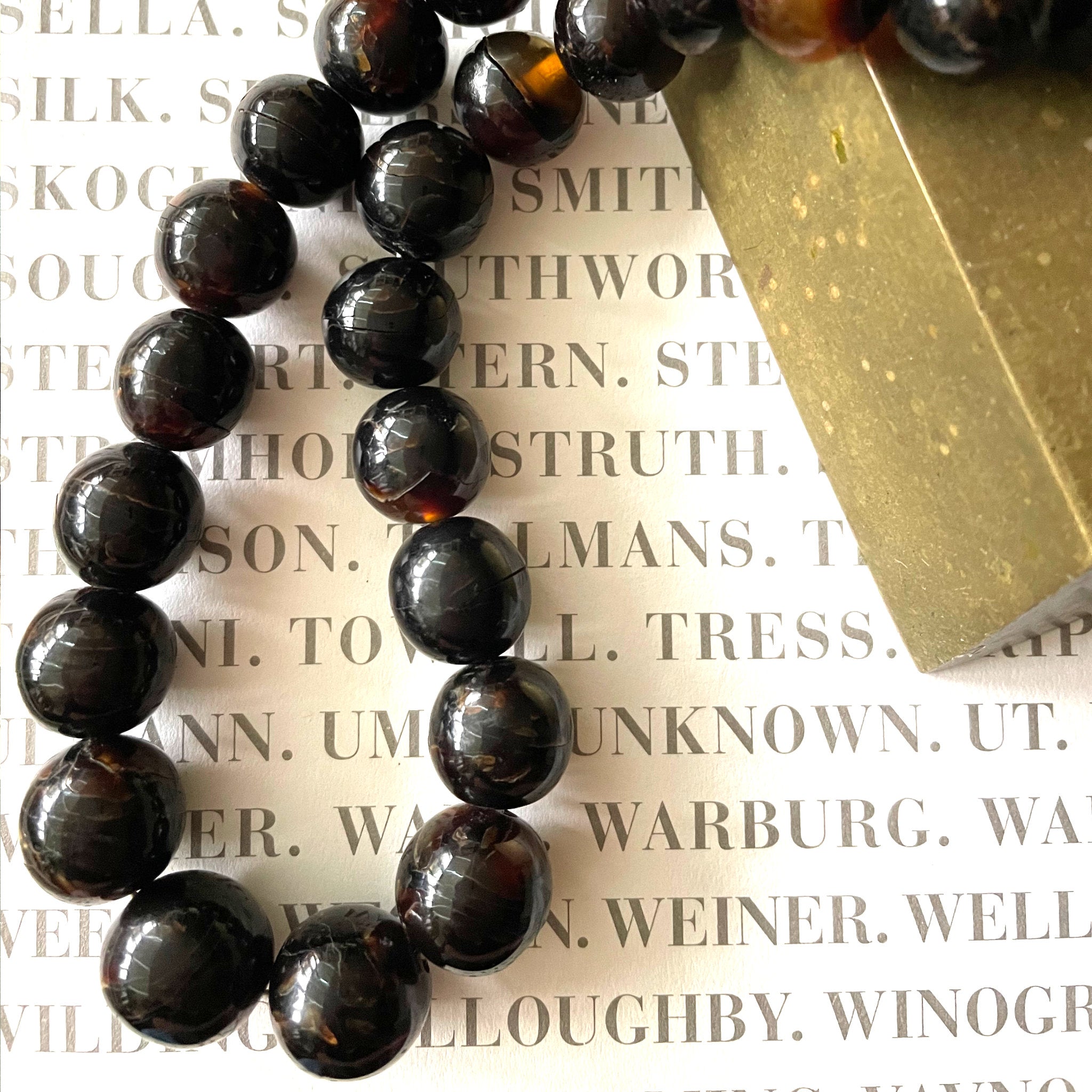 Tortoiseshell beaded necklace on printed background.