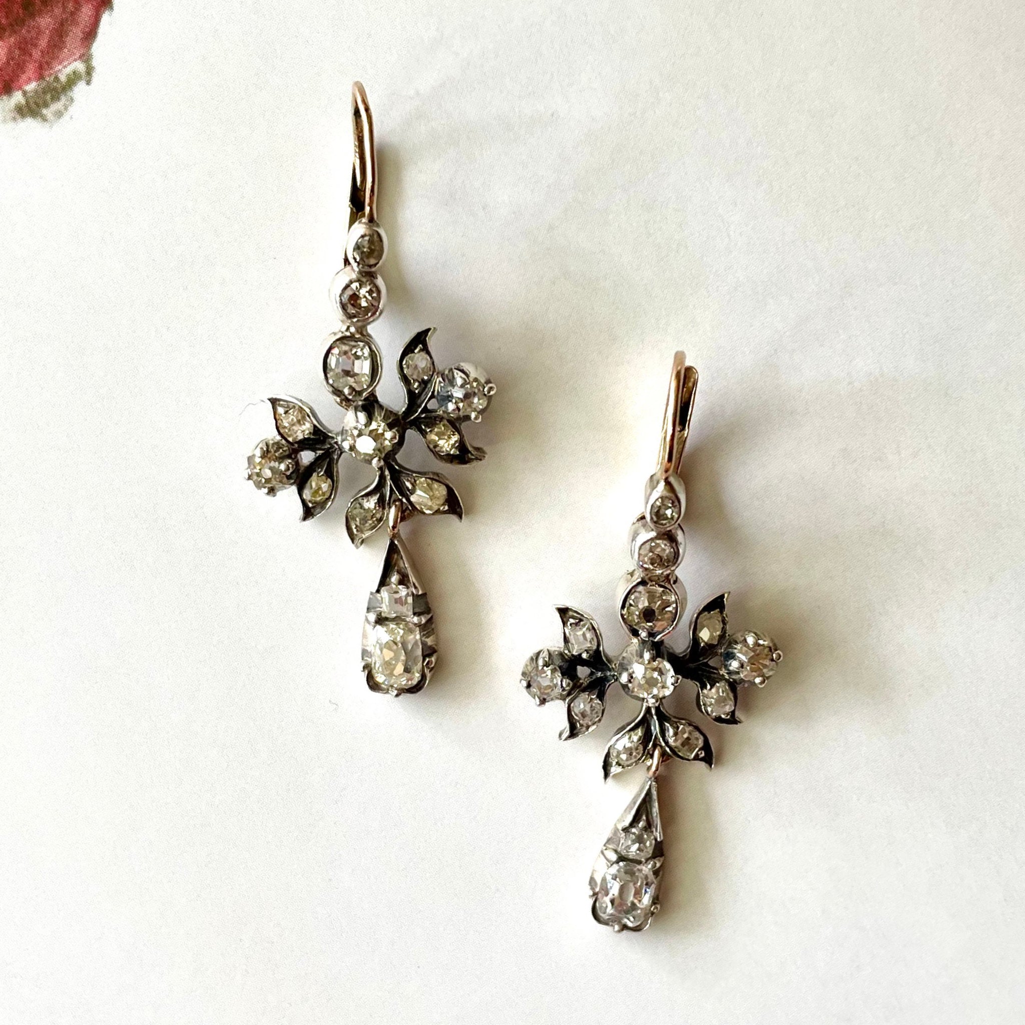 Nature inspired antique drop earrings on white background.