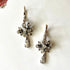 Nature inspired antique drop earrings on white background.