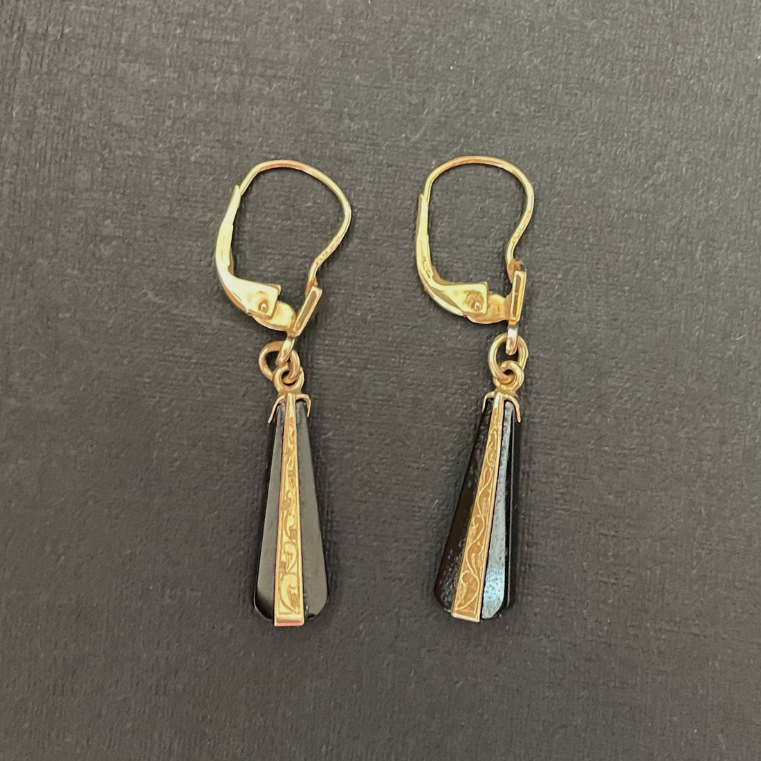 Black onyx drop earrings with etched gold detailing.Black onyx earrings in an art deco style.