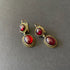 GArnet earrings with braided gold work.