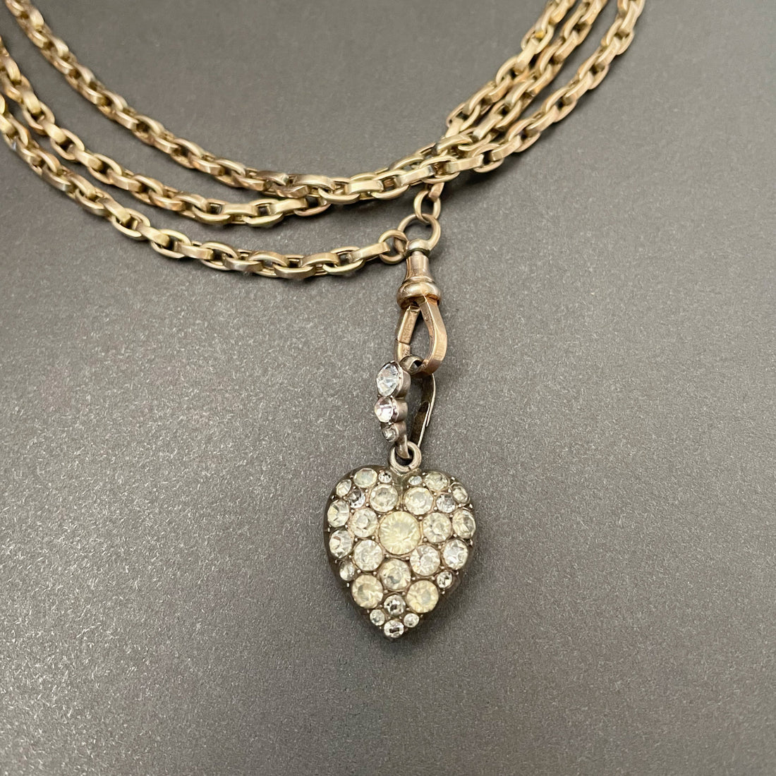silver heart shaped pendant with colourless paste stones in silver setting