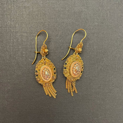 Gold drop earrings.