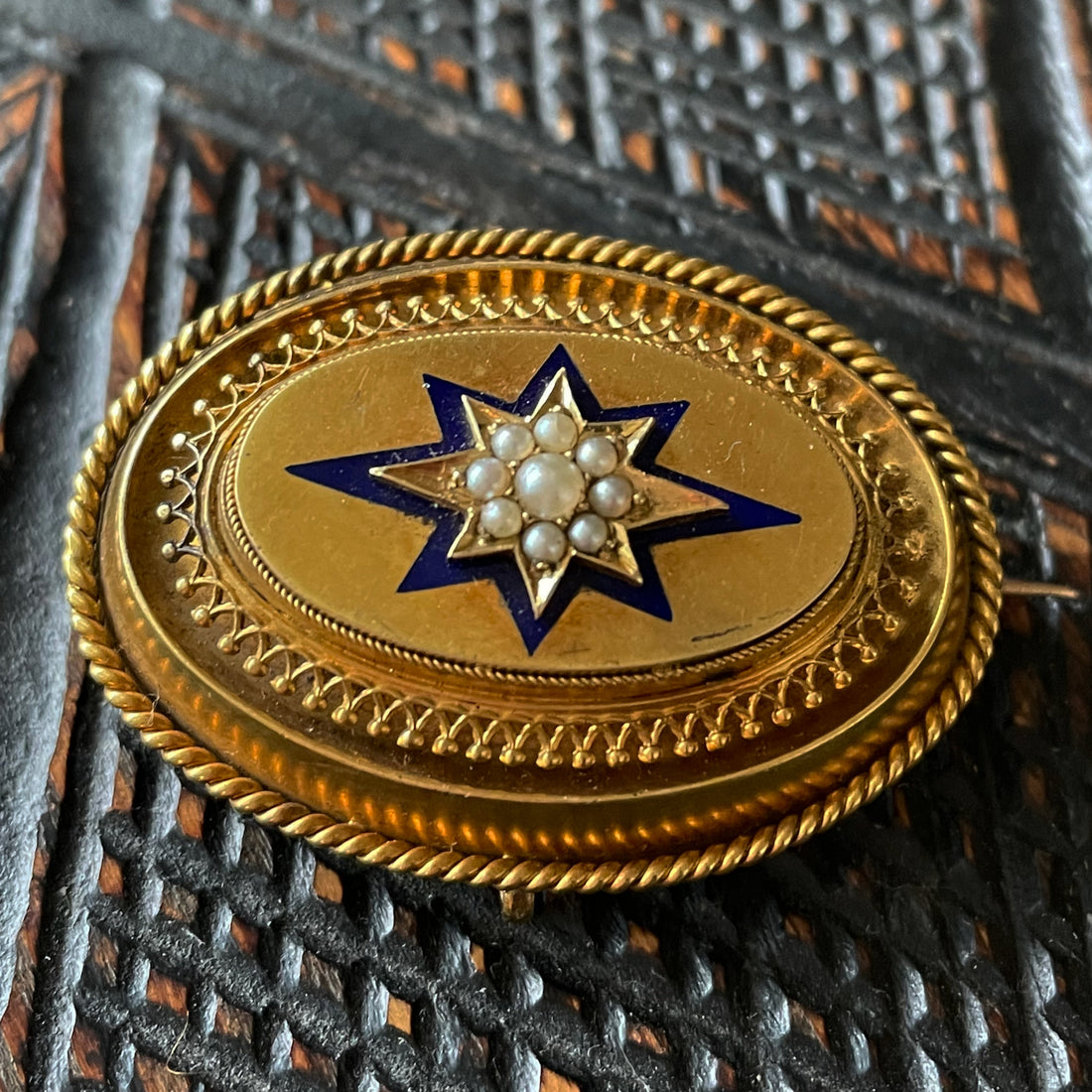 Victorian locket made of gold, pearls and blue enamel with intricate metalwork.