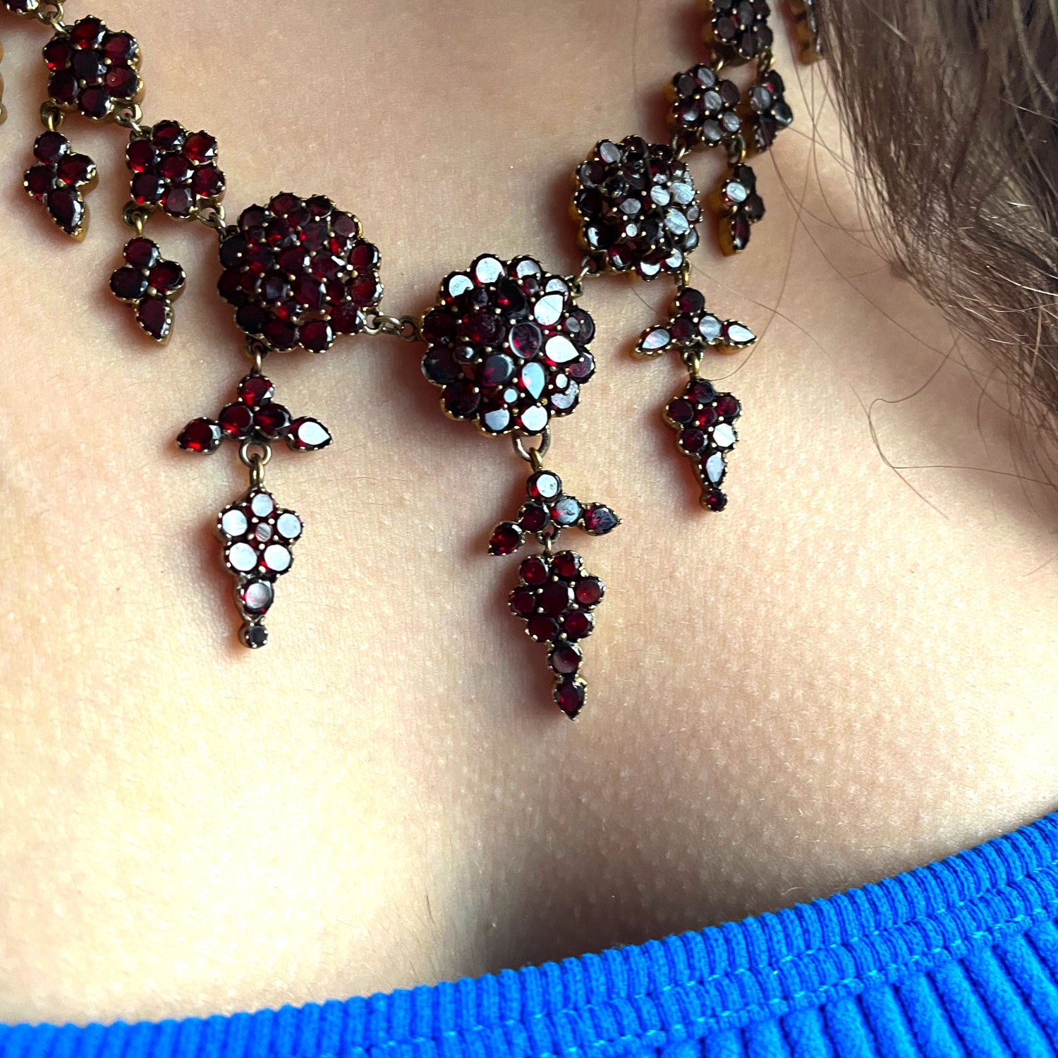woman wearing garnet necklace